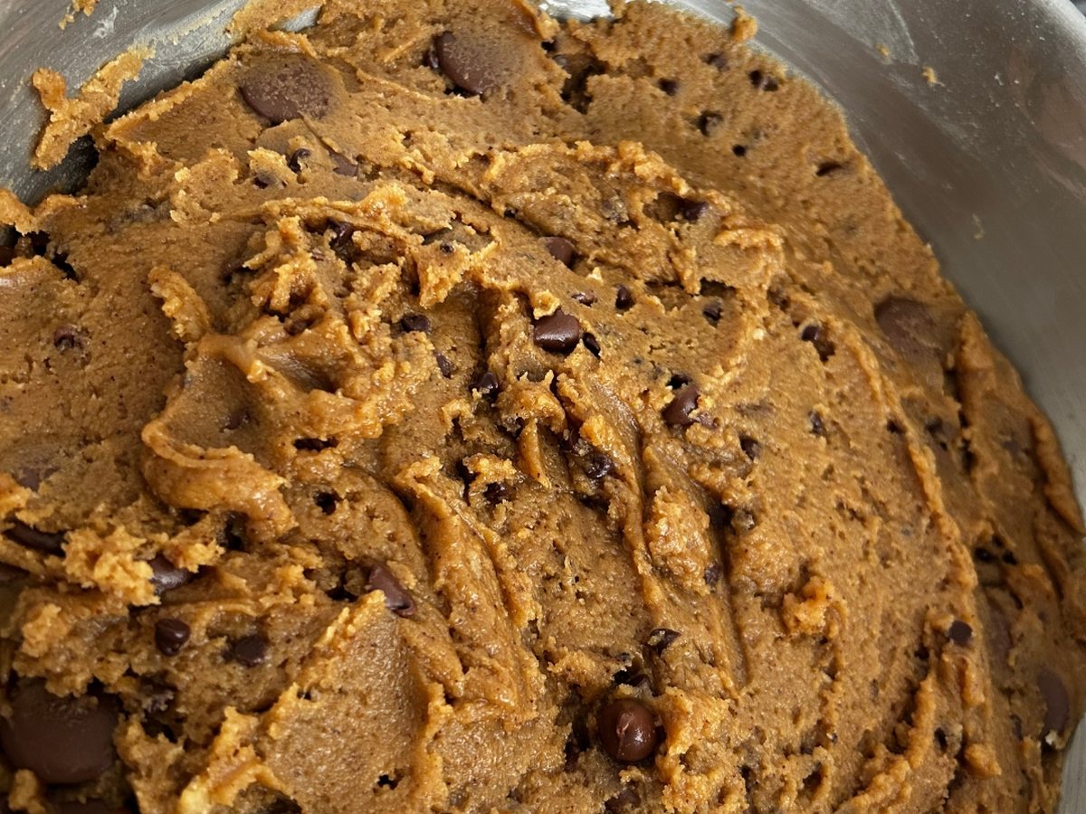 Hand-mixed brown butter chocolate chip cookie dough in a mixing bowl at Break of Day Bakery